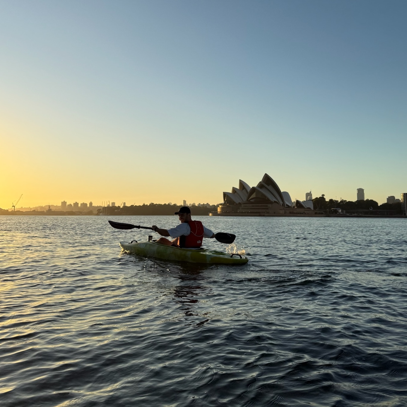 Victor kayaking in Sydney Harbour with the Opera House in the background.