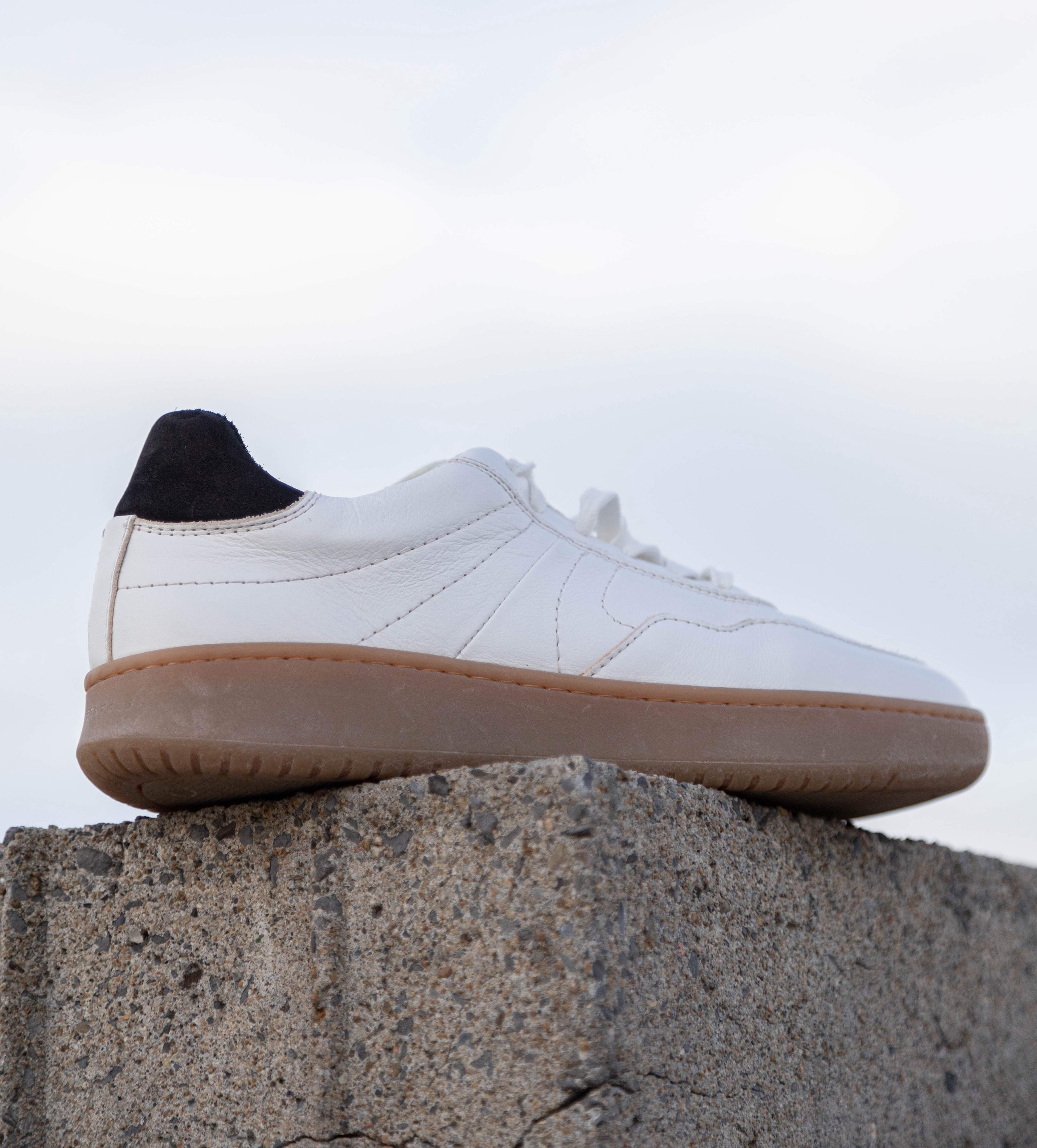 A side profile of simple & strange sneaker.